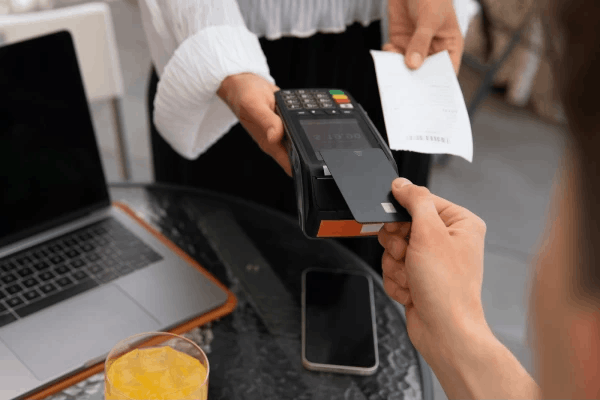 Person paying with card and receiving a receipt