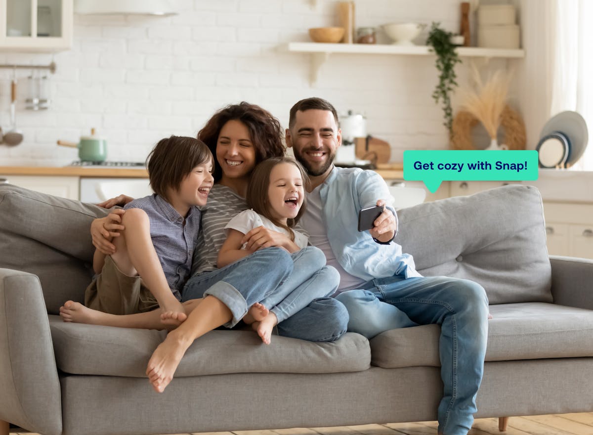 happy family on couch looking at phone