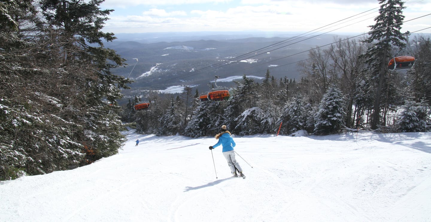 Skiing down Okemo Mountain Resort slope