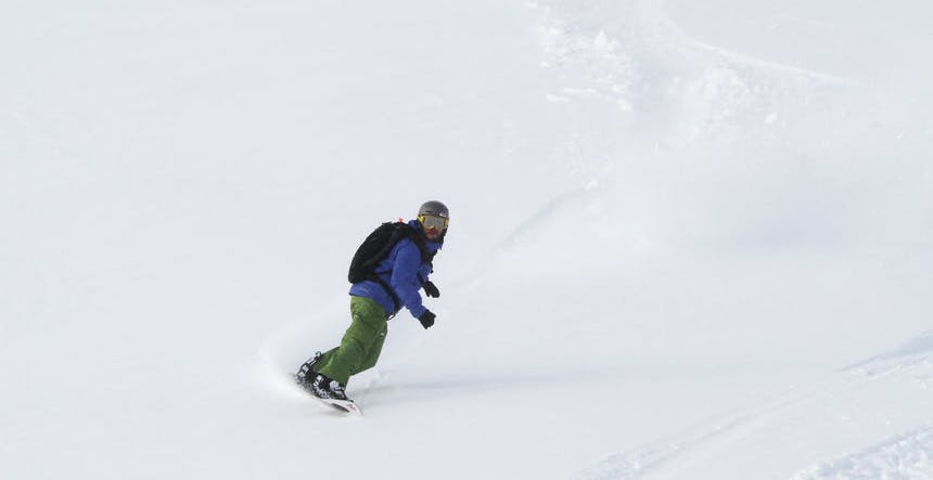 Snowboarding down a steep slope