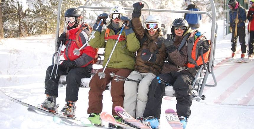 Friends on a chairlift at a ski resort