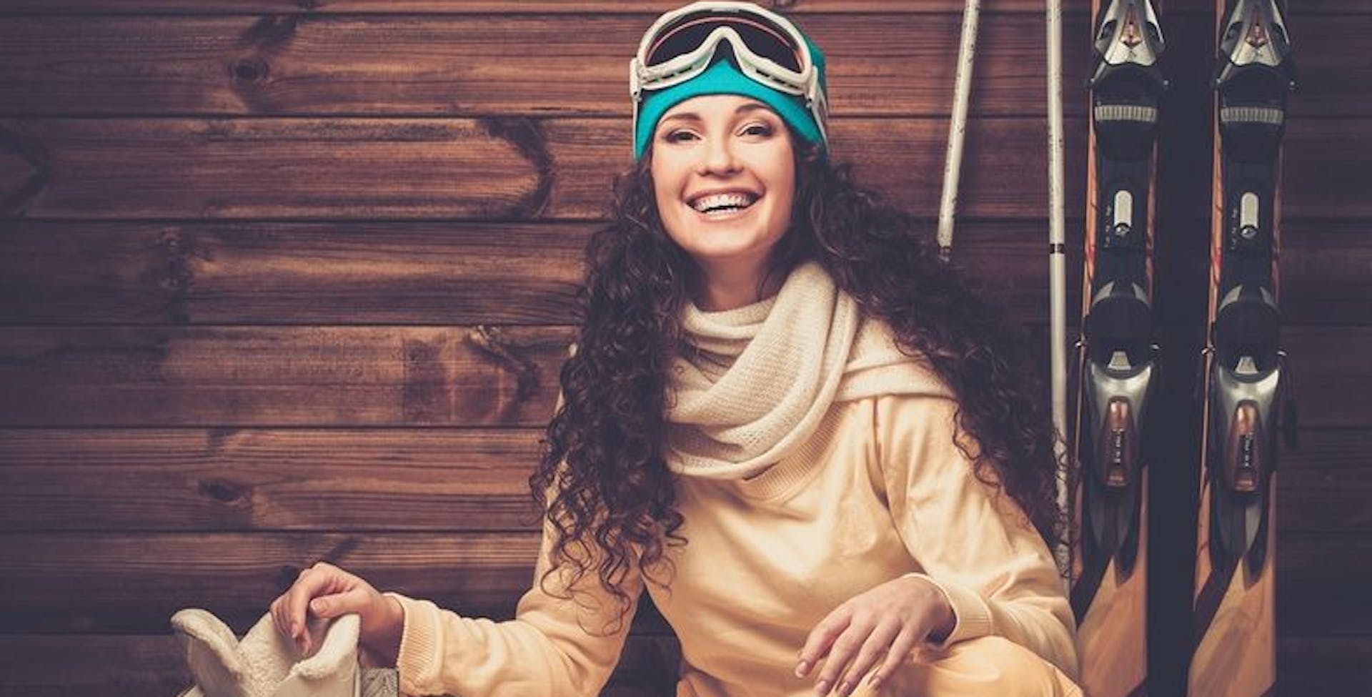 Happy woman with skis and ski