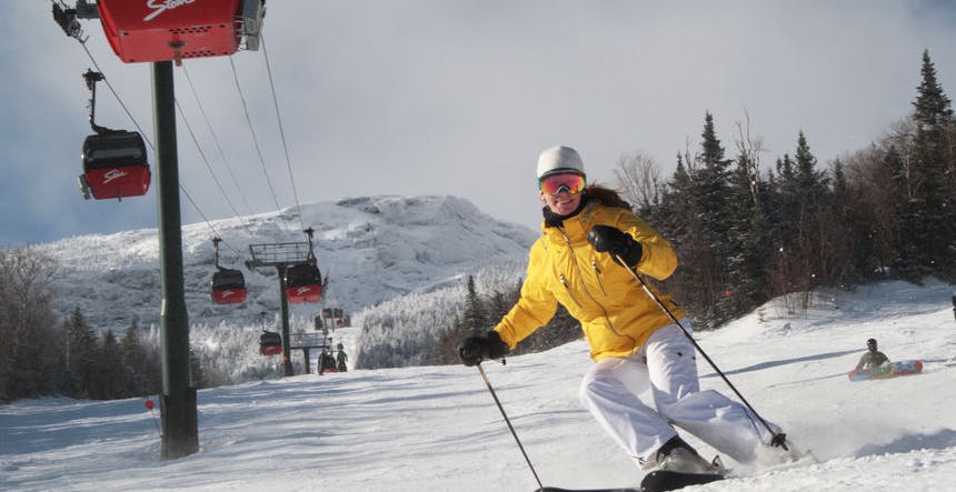 Skiing beneath the signature red gondola at Stowe