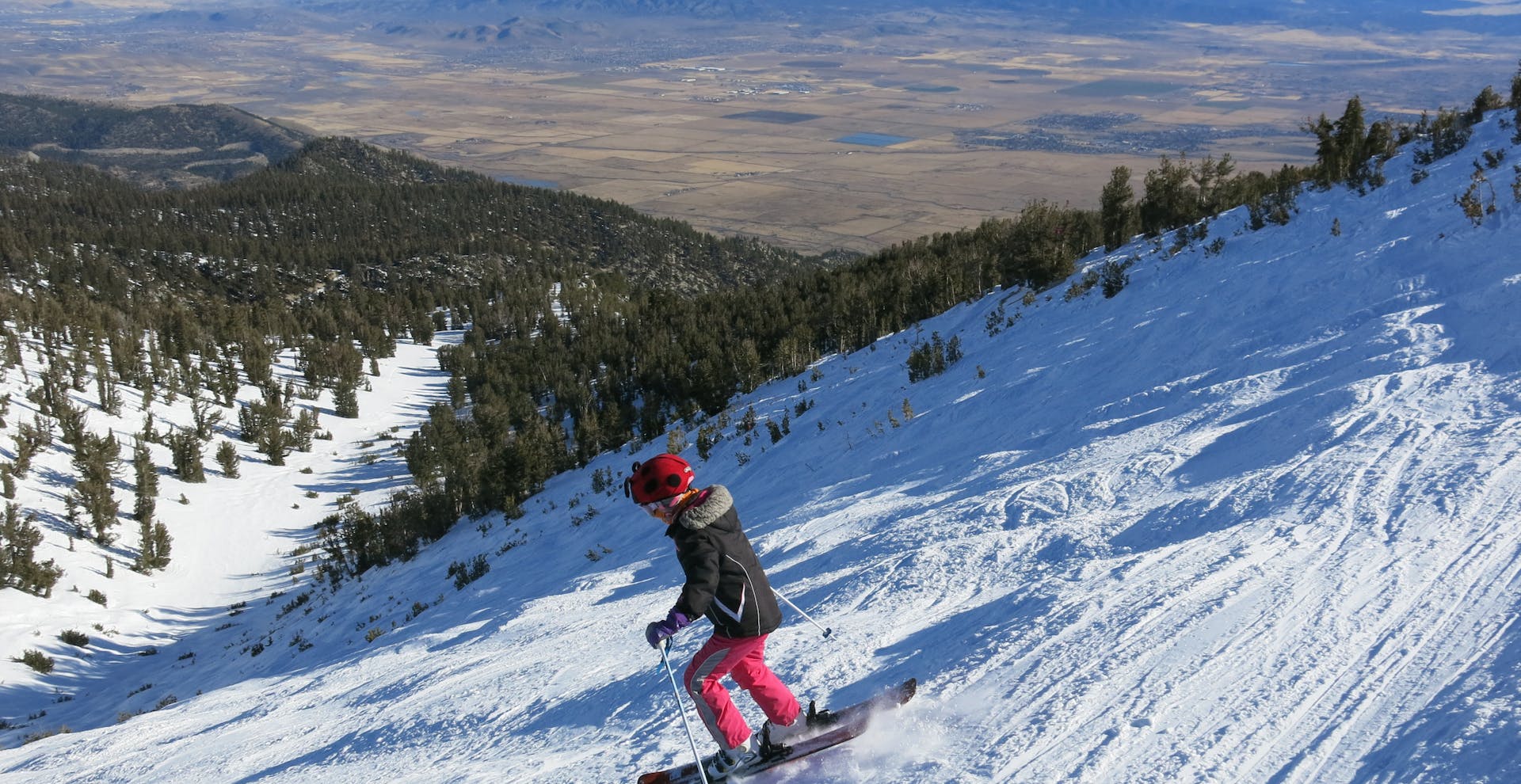 A kid skiing down a slope at Heavenly Ski Resort