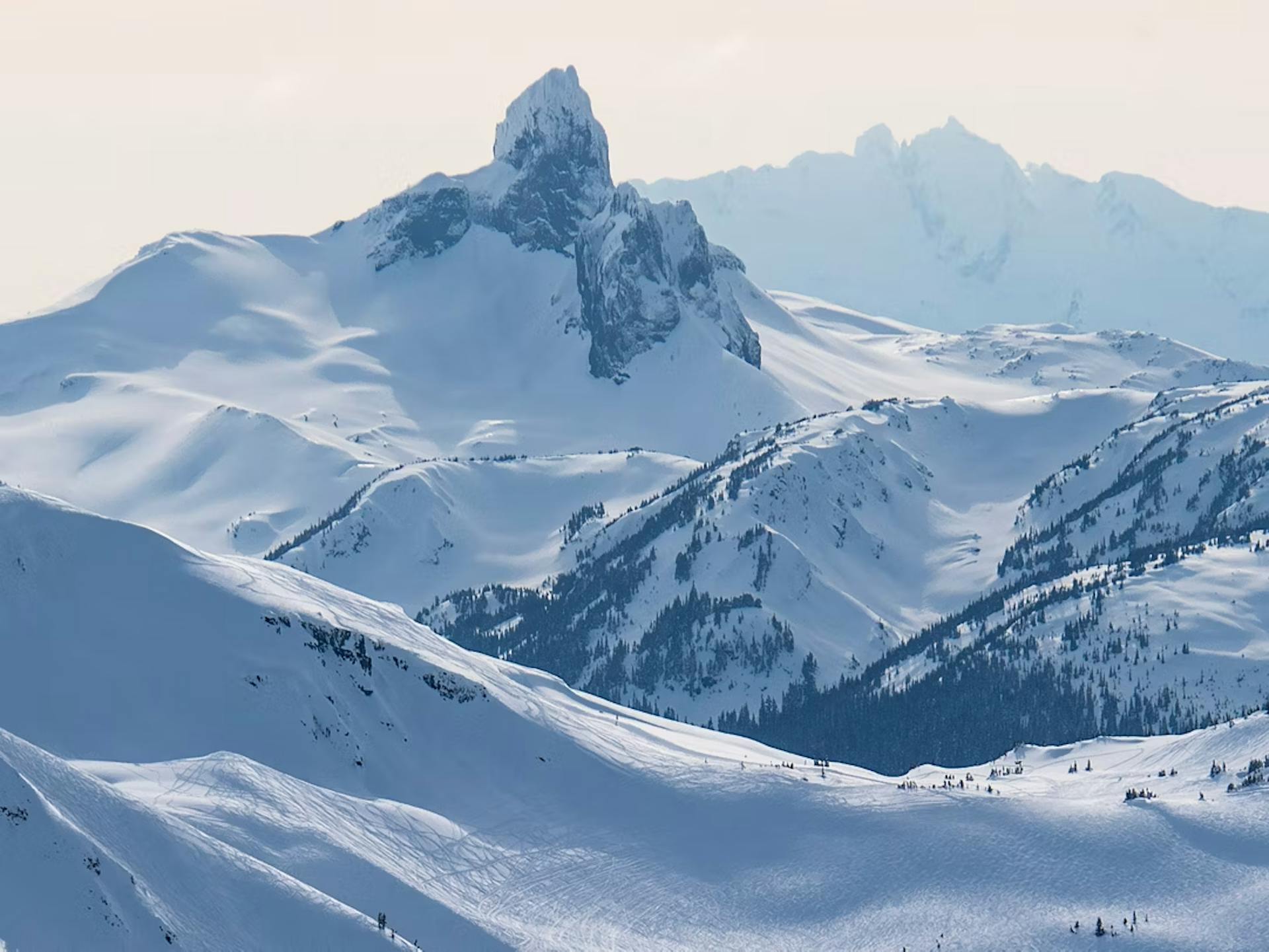 Dawn's first light hitting the snowy peaks of Whistler Blackcomb in British Columbia, Canada.