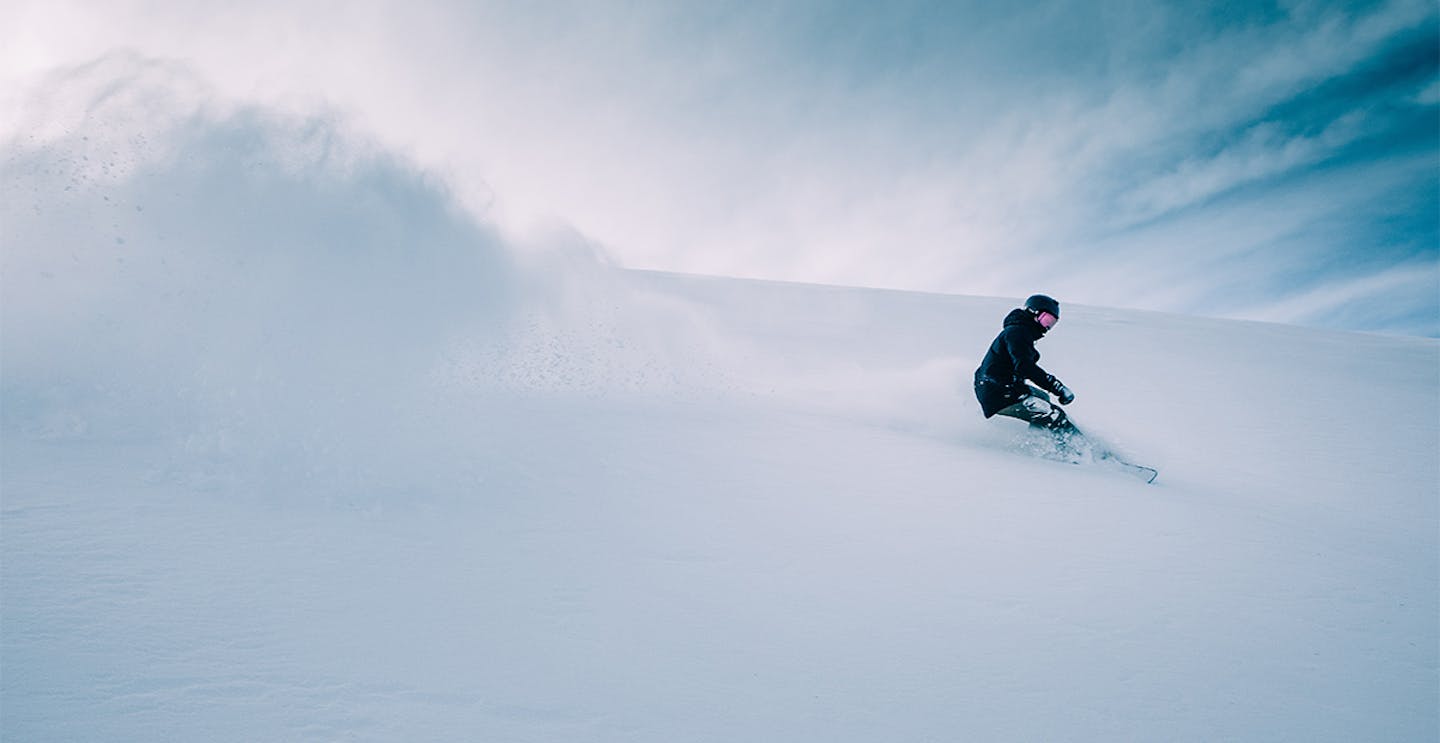 Skier of undiscernible gender in black ski jacket hitting the slopes at Hatley Pointe (Wolf Ridge) in North Carolina in the United States.