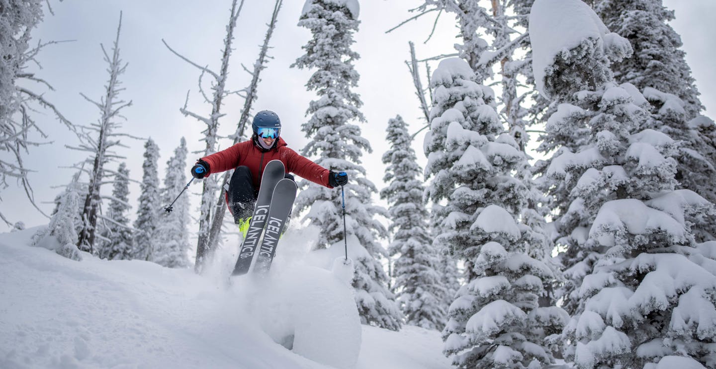 Male skier in red ski jacket hitting the slopes at Brundage Mountain in Idaho, USA.