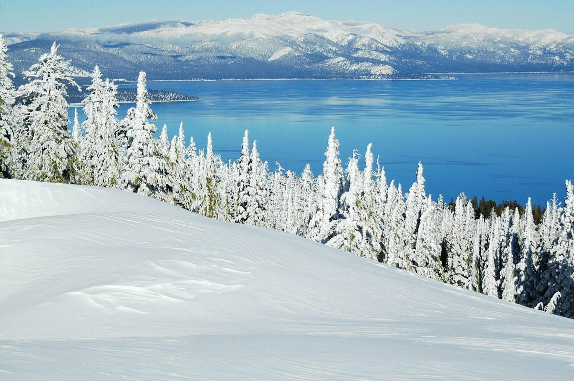 Lake Tahoe in the Sierra Nevada Mountains covered in snow.