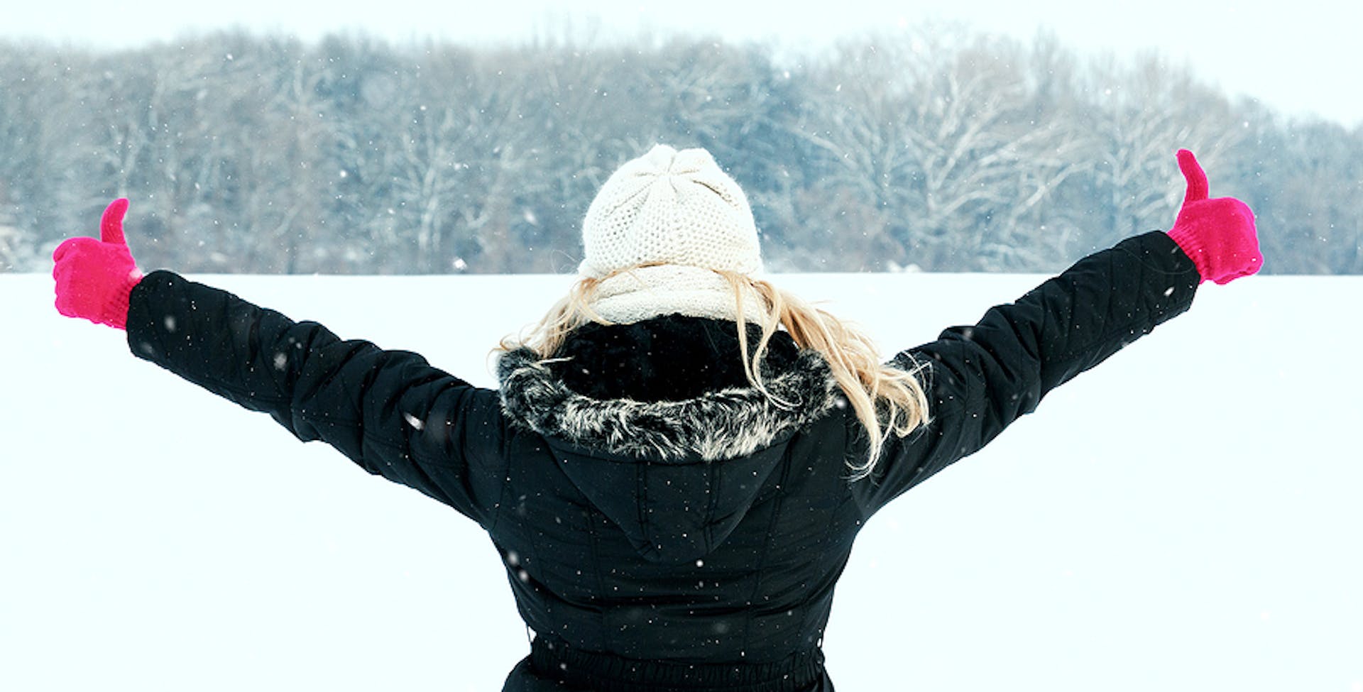 Woman in snow showing her back