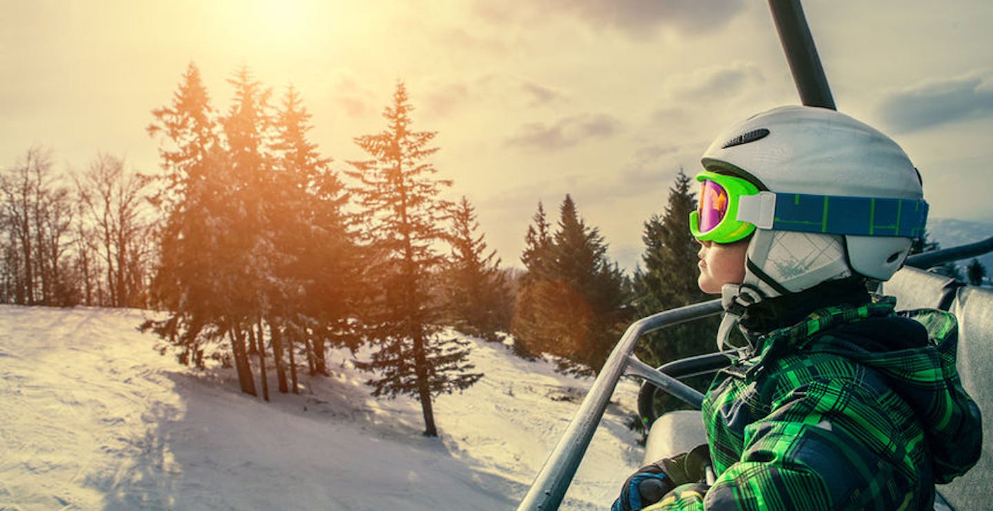 Little skier on the ski lift