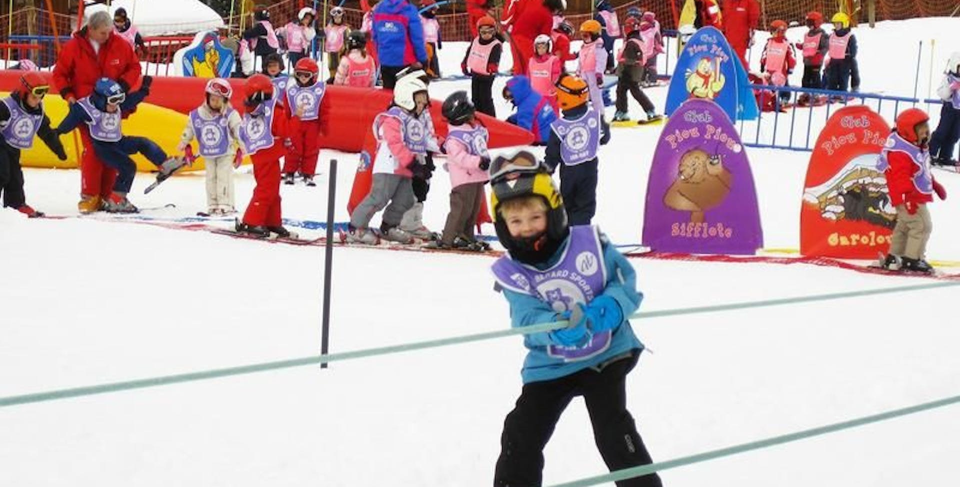 Kid skiing with crowd