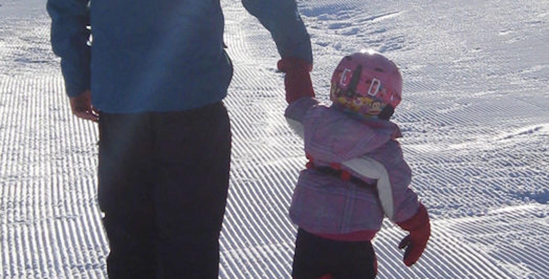 Kid with grandfather on the snow