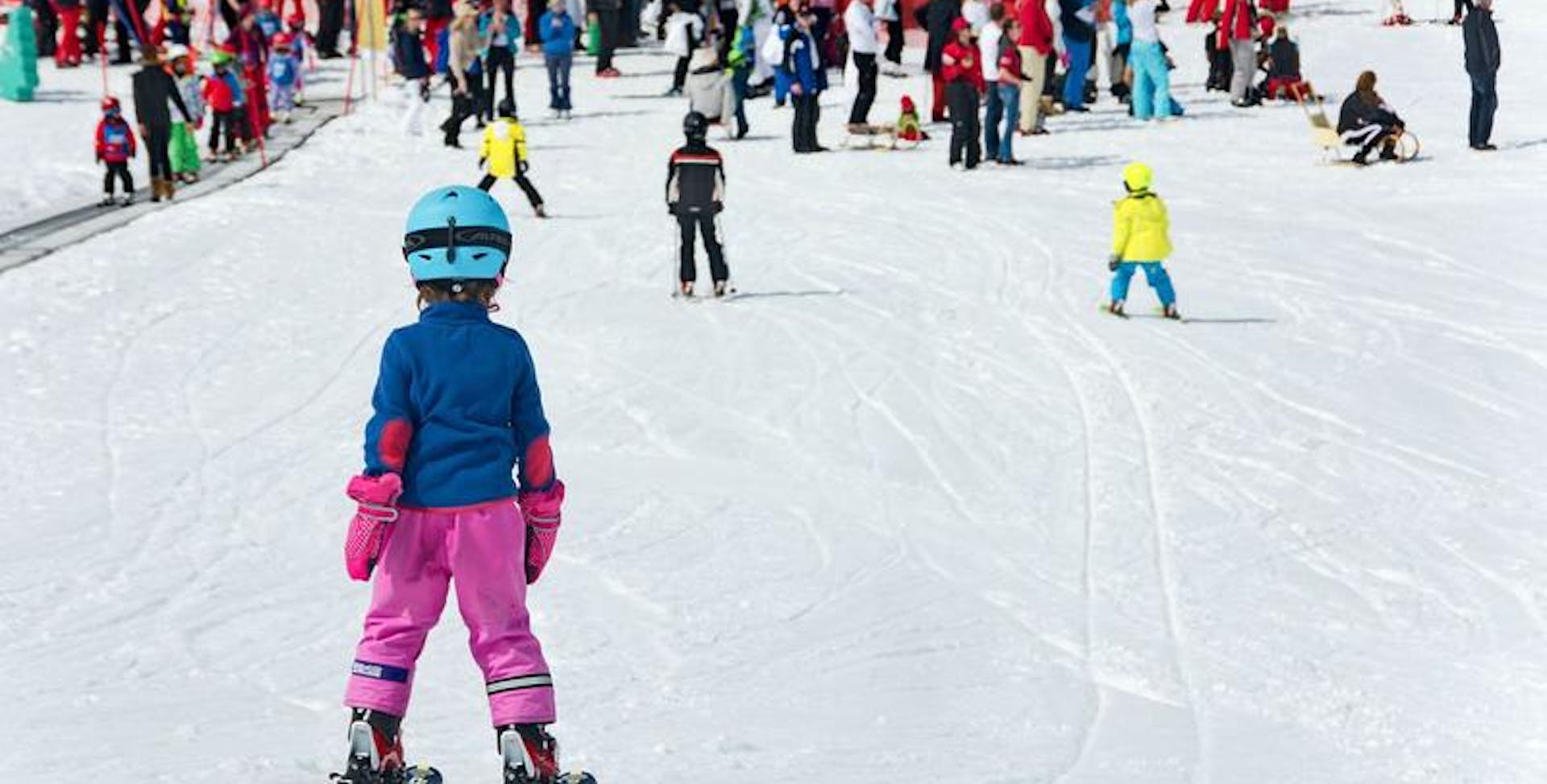 Kid skiing in front of crowd