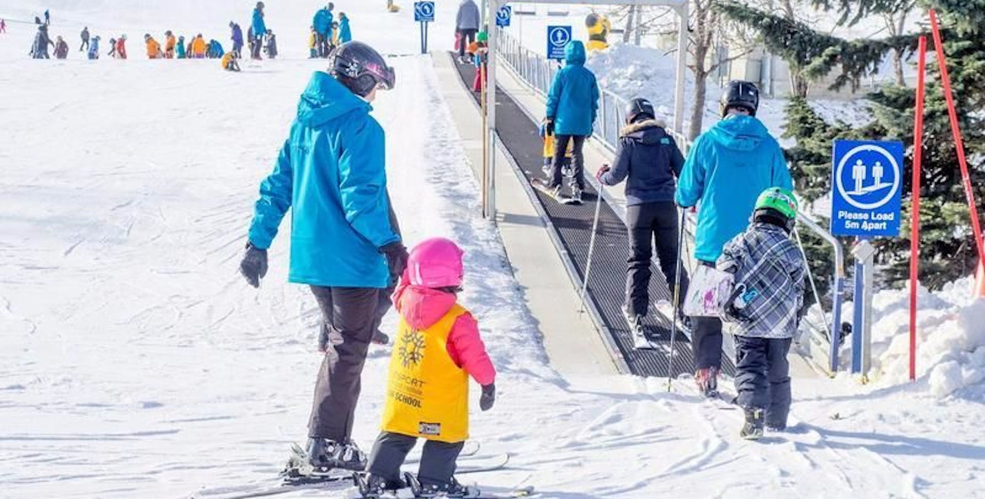 Adults and children skiing.