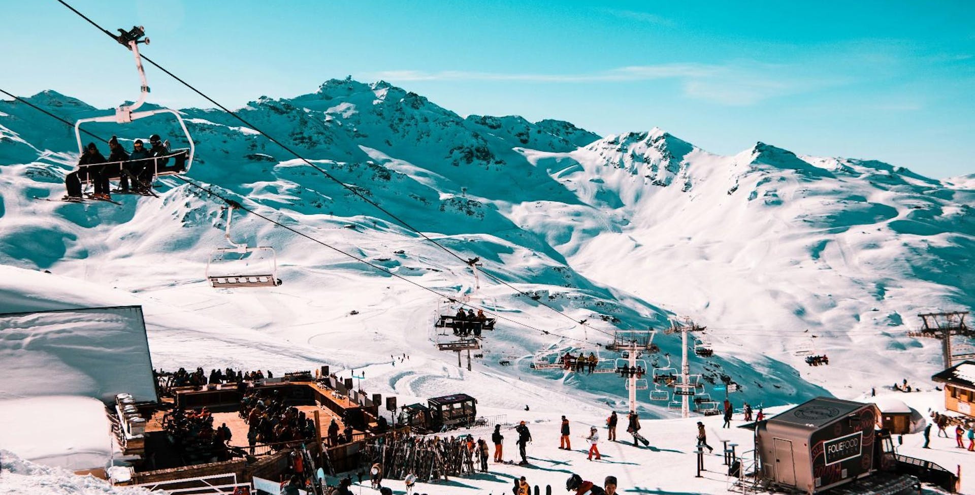 people party at la folie douce in val thorens under a perfect blue sky