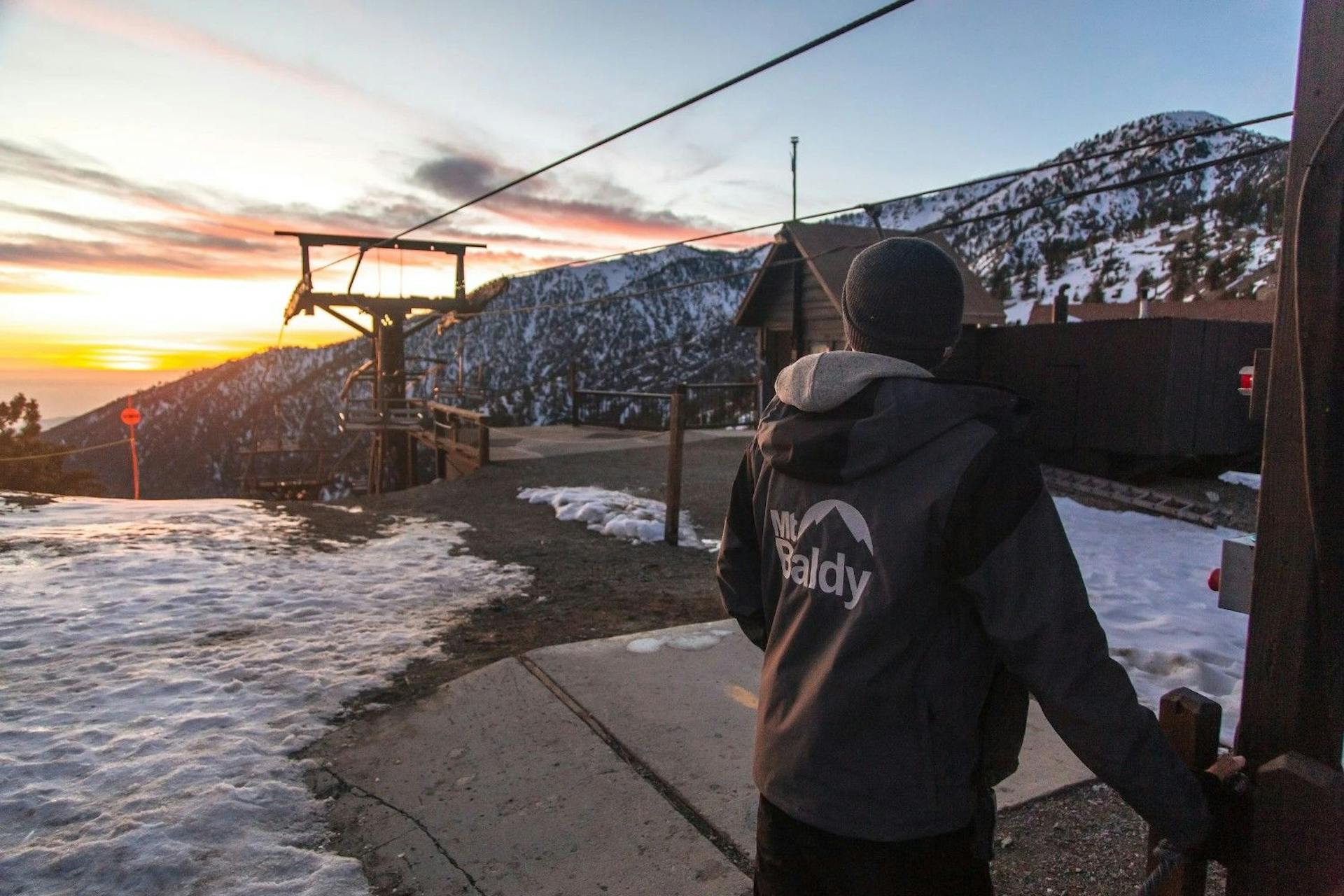 Mt. Baldy worker near the chairlift at sunset at Mt. Baldy near Los Angeles in California, USA.