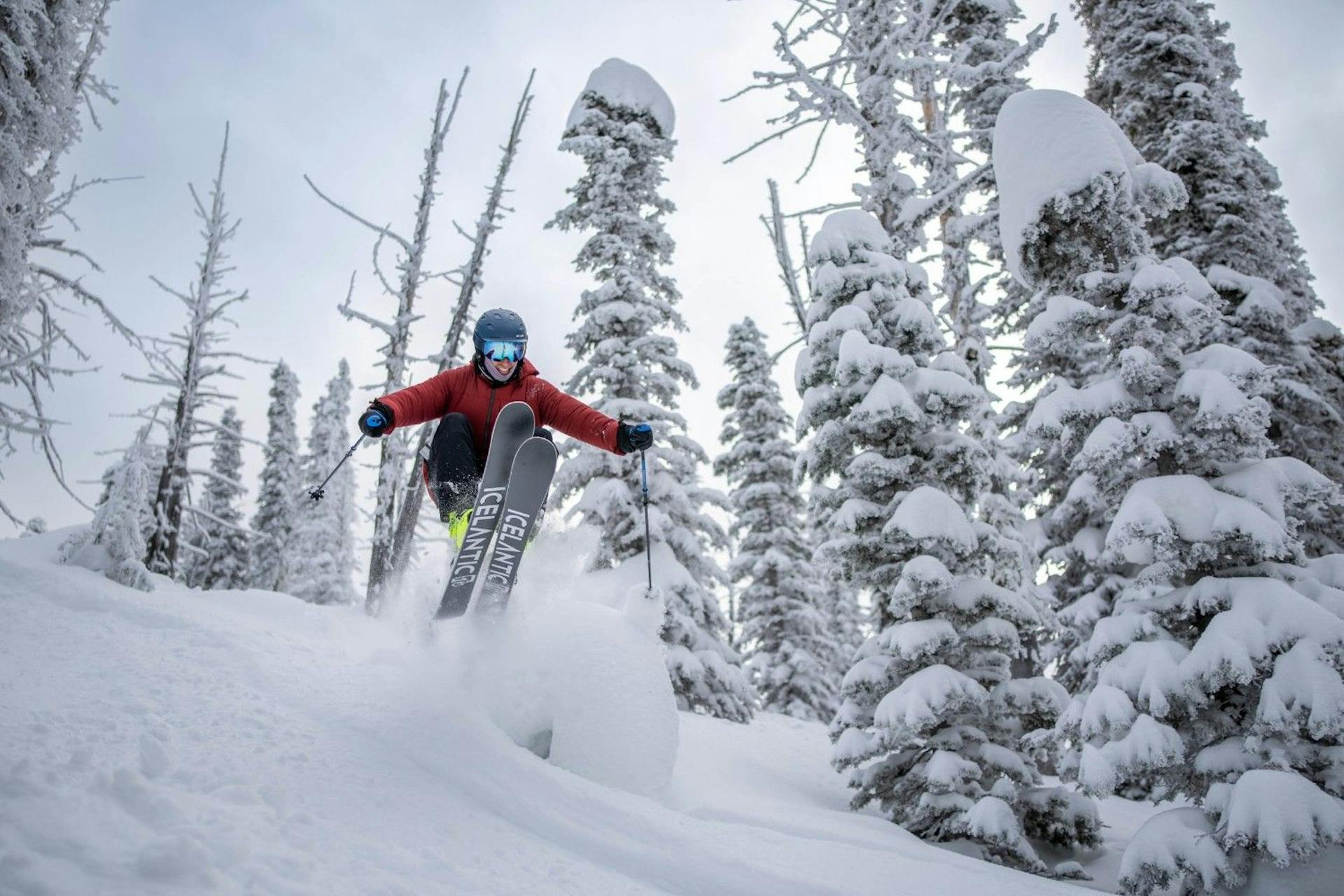 Male skier in red ski jacket hitting the slopes at Brundage Mountain in Idaho, USA.