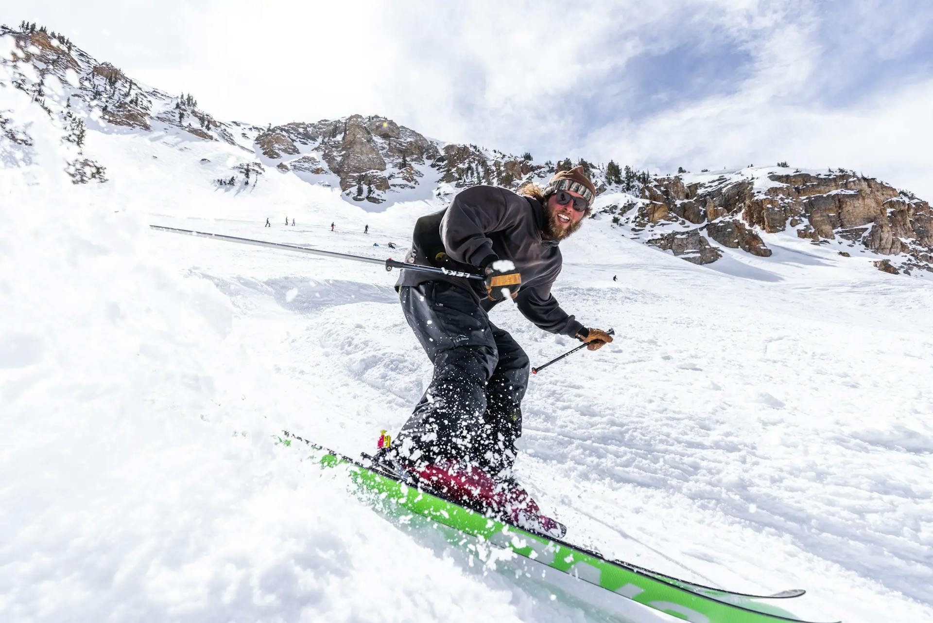 Male skier in dark-colored ski attire hitting the slopes at Alta in Colorado, USA.