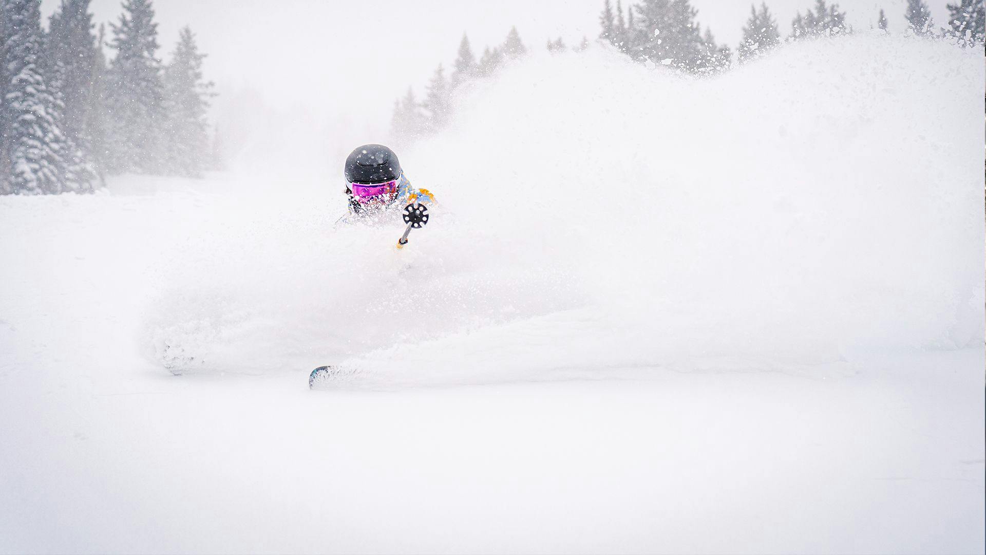 Skier of undiscernible gender hitting the slopes of Snowbird Ski Resort in Utah, USA.