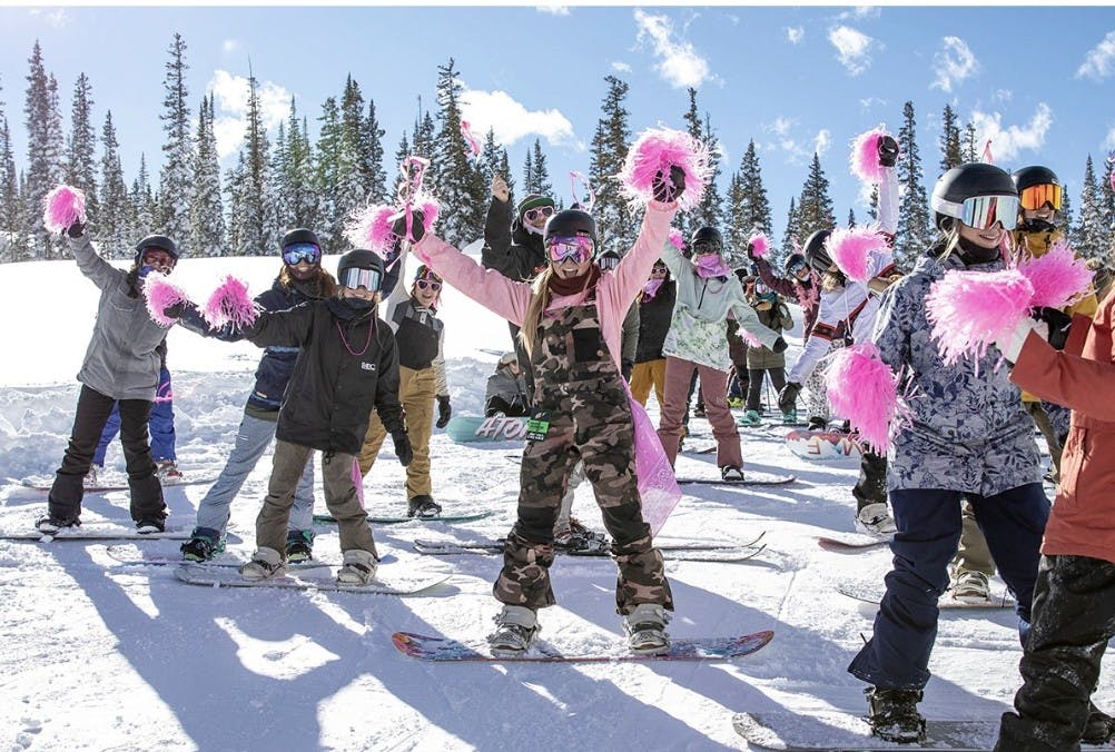 Diverse group of snowboarders in colorful ski attire hitting the slopes at Grand Targhee Resort in Wyoming, USA.