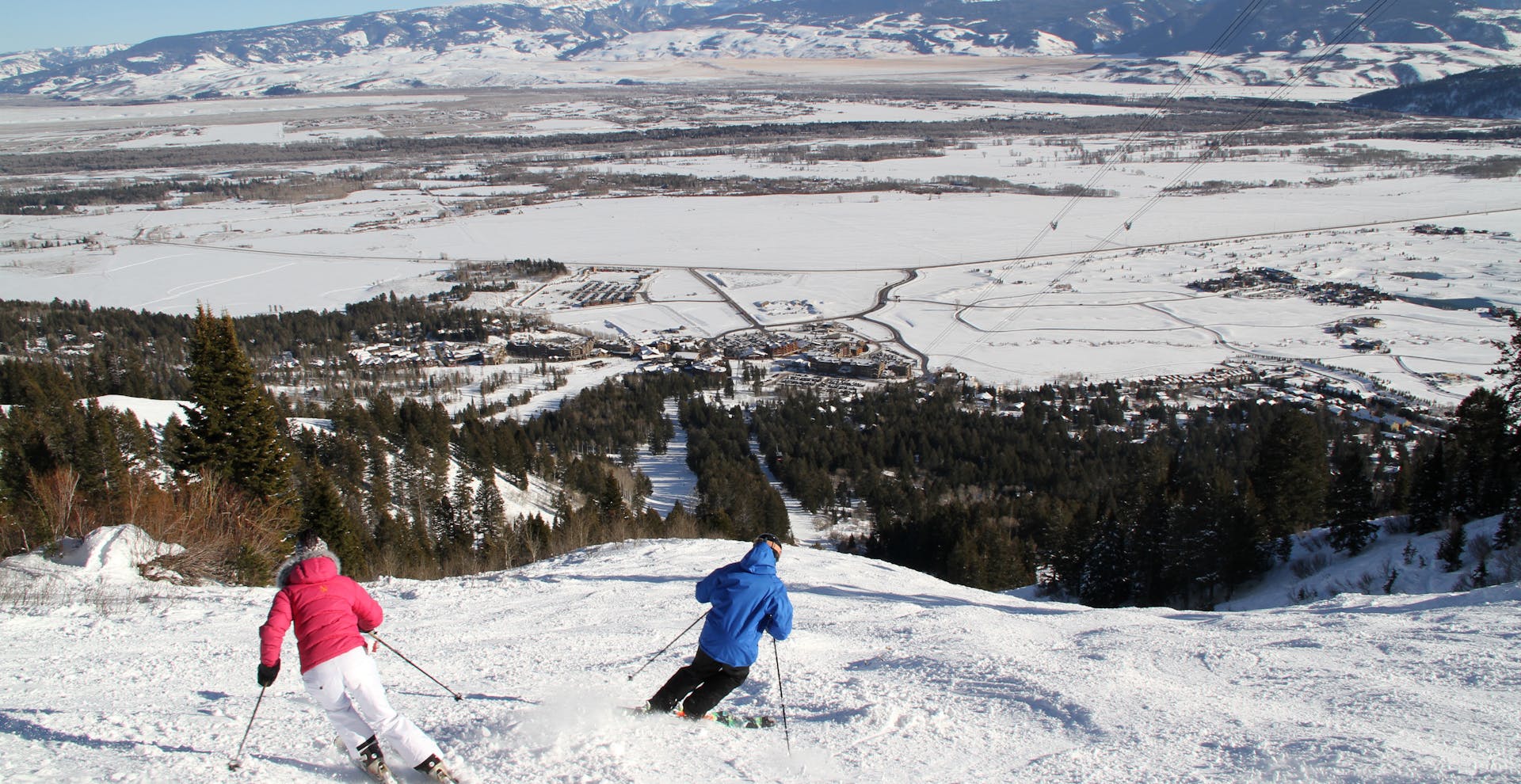 Couple skiing down Jackson Hole slope