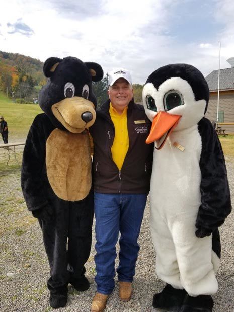 President Wesley Kryger with mascots Arktos (left) and Filos (right)