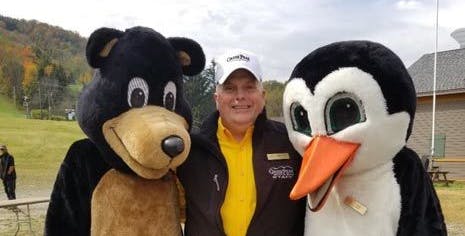 President Wesley Kryger with mascots Arktos (left) and Filos (right)
