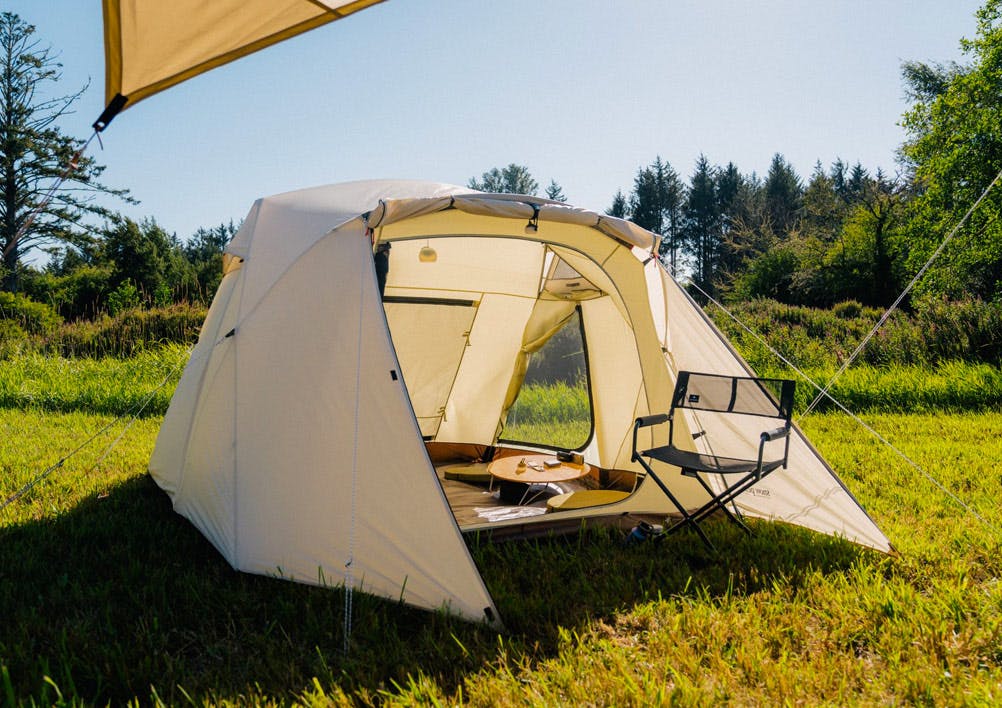 A photo of an ivory Alpha breeze tent lit up by sunlight