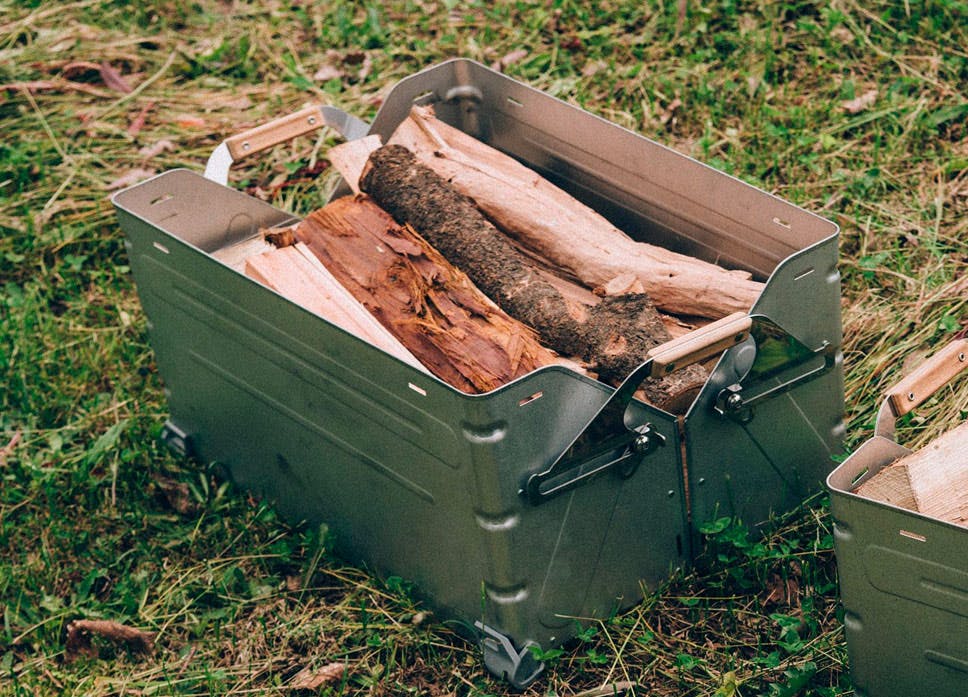 a metal box with firewood in it