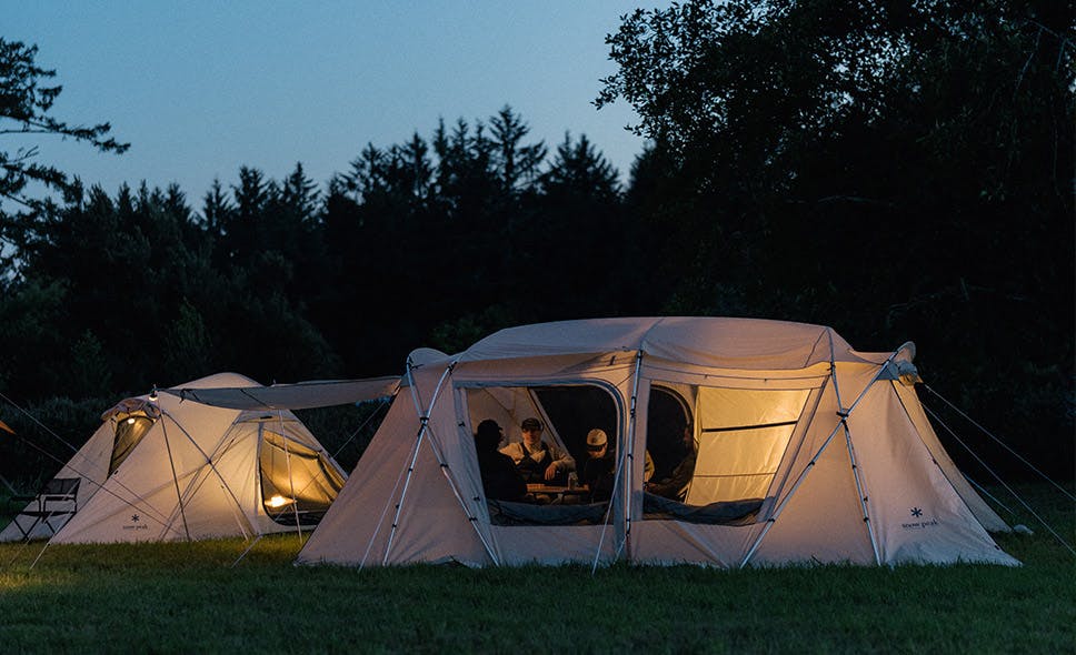 a photo of a large ivory tent at night