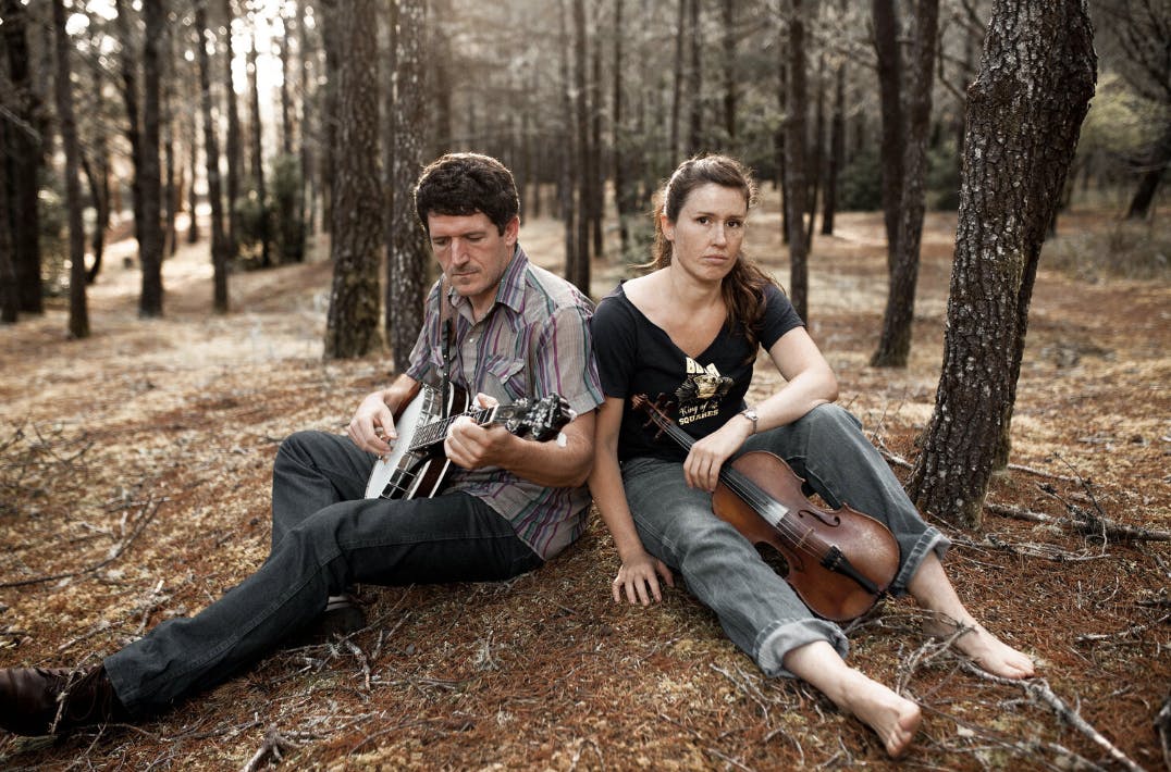 The Horsenecks sitting in the woods playing music