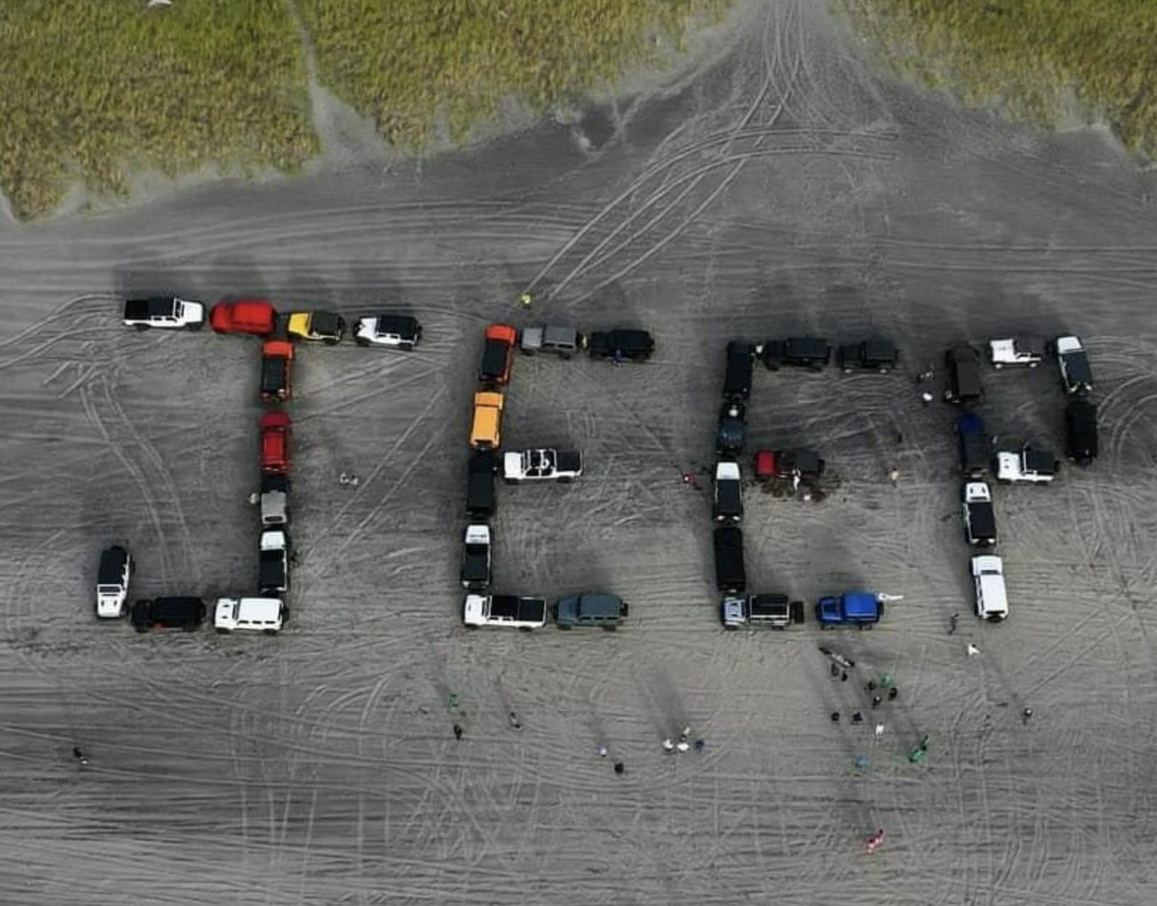 Jeeps spelling out Jeep on the beach