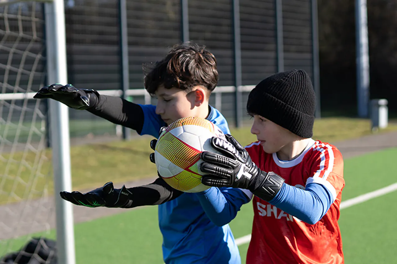 Kids practicing goalkeeper technique with ball handling drills - PWR PLY Soccer Academy