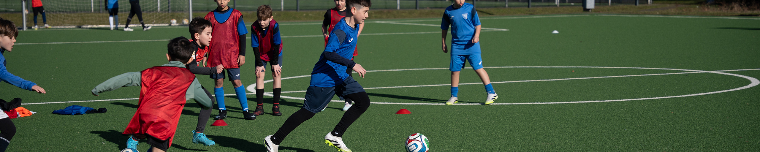 Kinder im intensiven Training mit Ball und Teamübungen – PWR PLY Soccer Academy