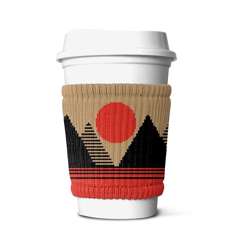 customized sun and mountain knitted cozy wrapped around a white coffee takeaway cup