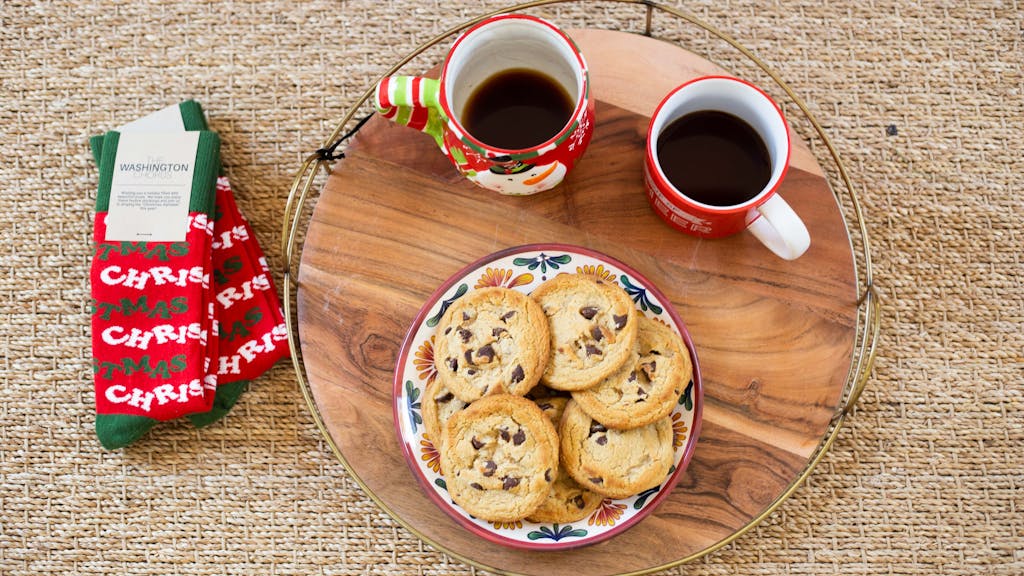 Custom socks sitting next to tray of cookies and coffee