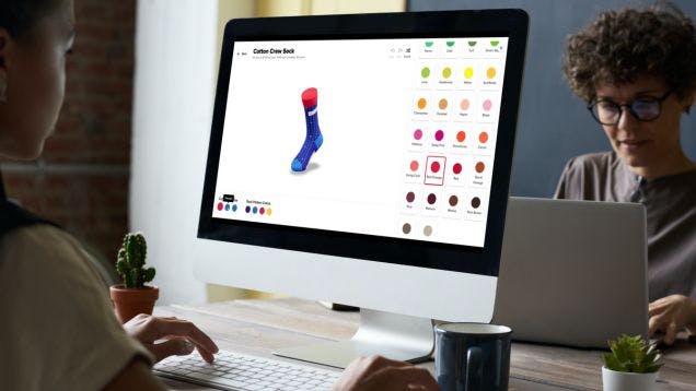 A woman designing custom socks online at her desk through Sock Club's online sock design builder