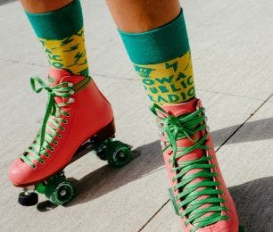 Socks with logo for fundraising for Iowa Public Radio being worn by a donor wearing roller skates