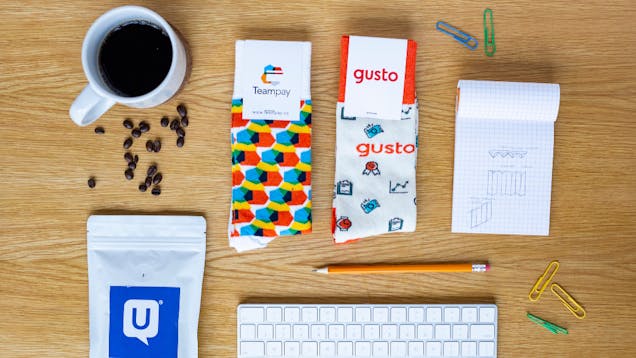 Desk with custom socks, coffee, and office items