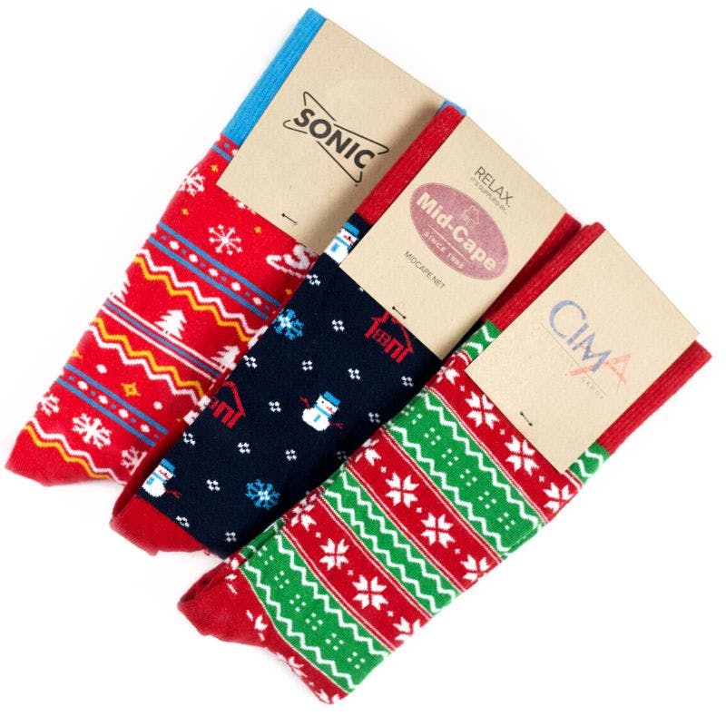 Three custom holiday socks showcasing ugly sweater designs in red, green, blue, and white for Sonic, Mid-Cape, and CIMA