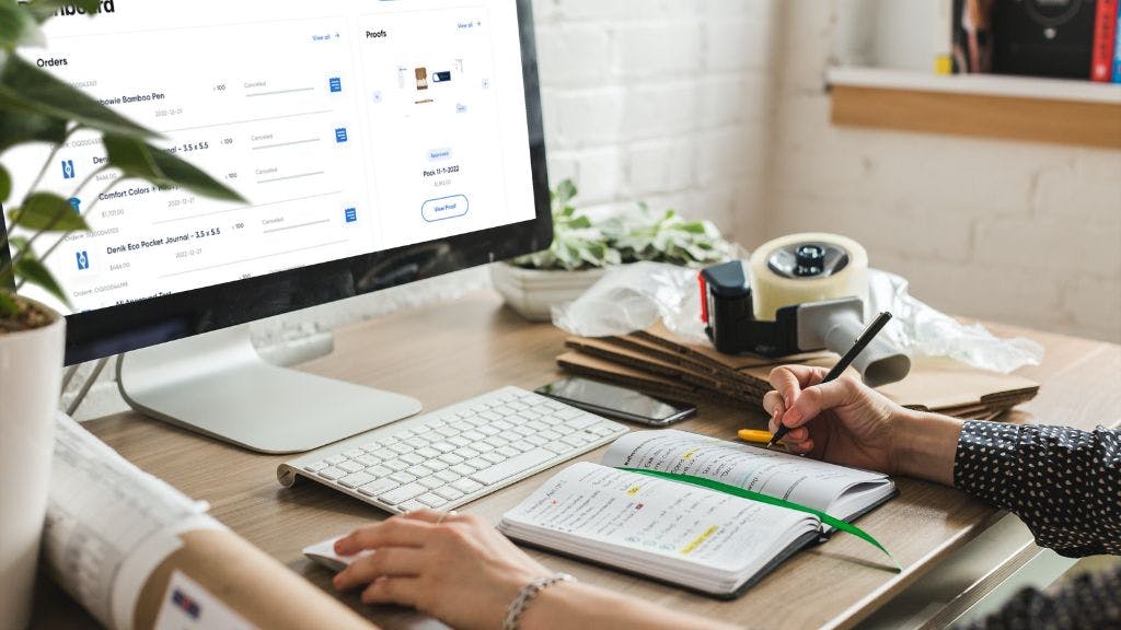A brand manager working on a new company swag store at her desk in her home office