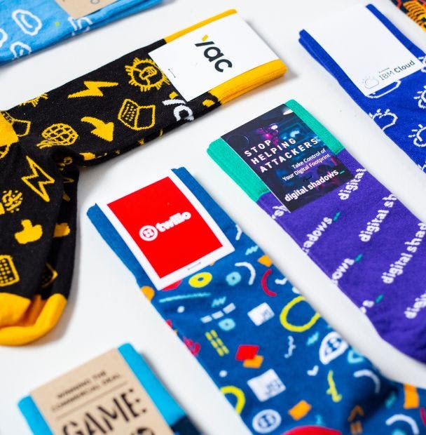 Colorful custom crew socks made for a variety of companies, including Twilio, Digital Shadows, IBM Cloud, and YAC