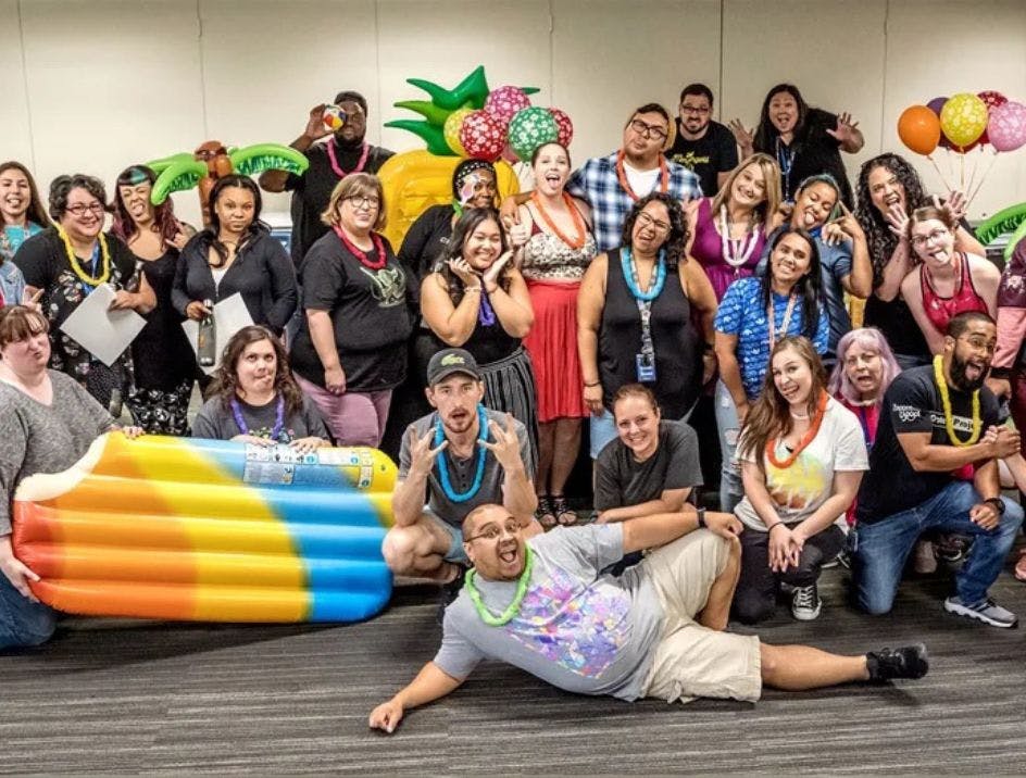 The team at Zappos in their office celebrating a pool party themed event