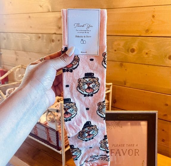 Custom wedding socks showing a sock design showcasing the couple's dog and wedding date on the wedding favor
