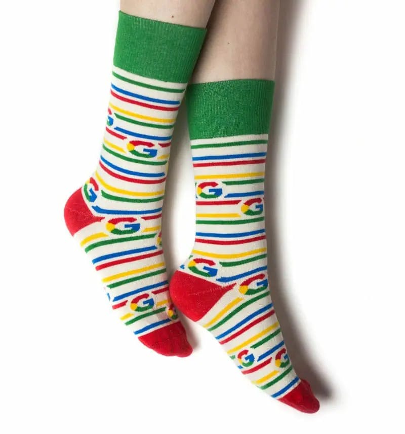 Model wearing customized branded knitted socks for Google, with repeating google logo and branded colors
