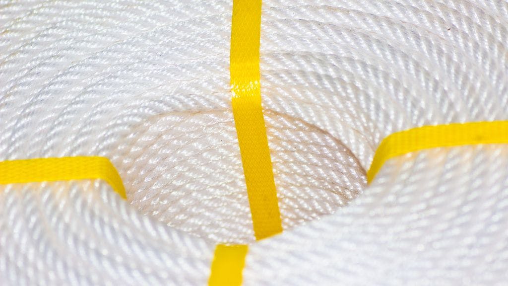 Spool of nylon yarn coiled together and held with yellow bands