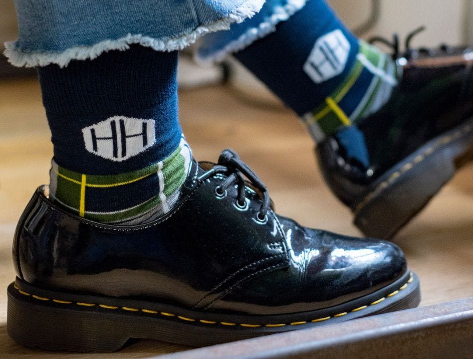 Plaid custom dress socks for HH on an employee's feet wearing dress shoes