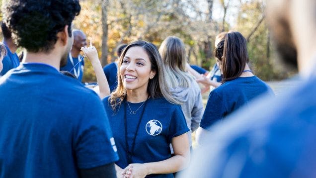 Woman in a blue t-shirt at an event selling custom merchandise