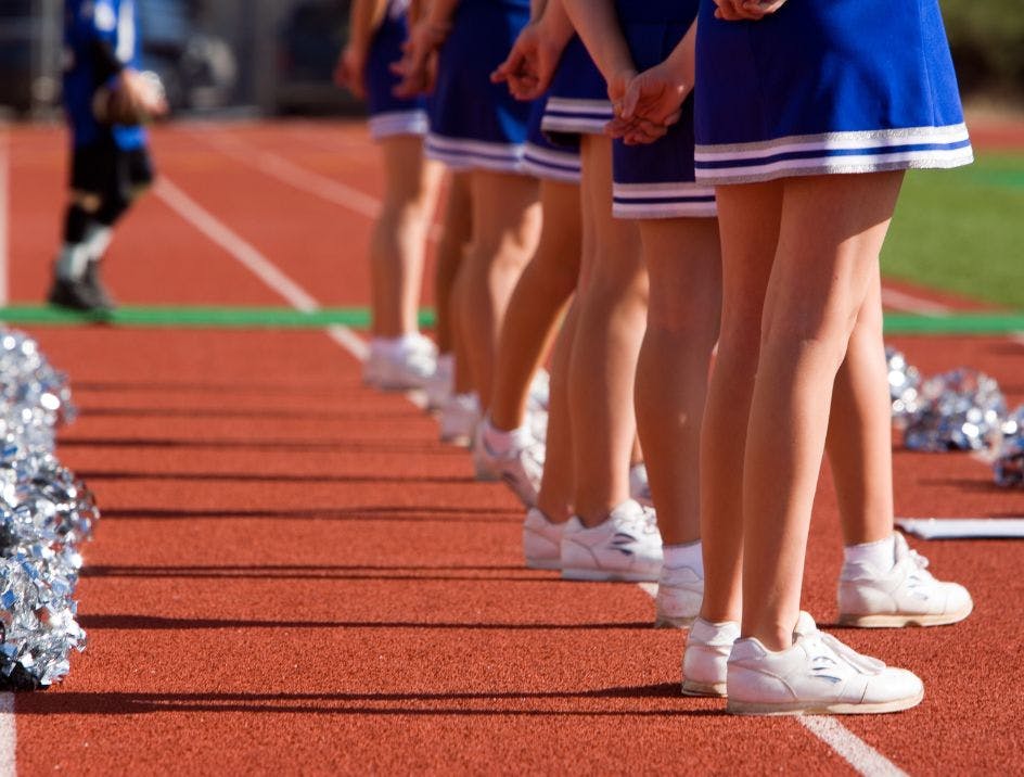 A cheerleading squad on the football field wearing ankle socks for cheerleading