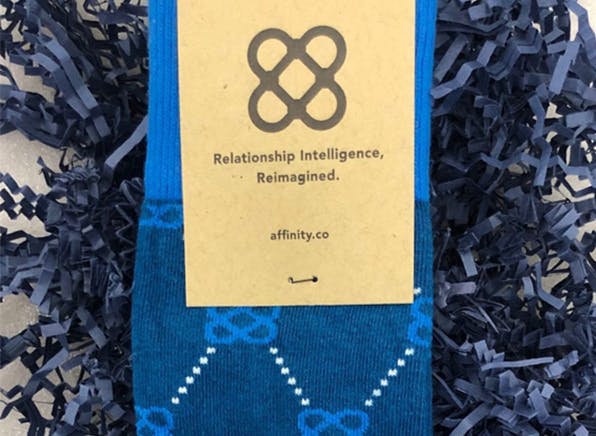 Blue Affinity custom socks with custom sock packaging for trade show giveaway